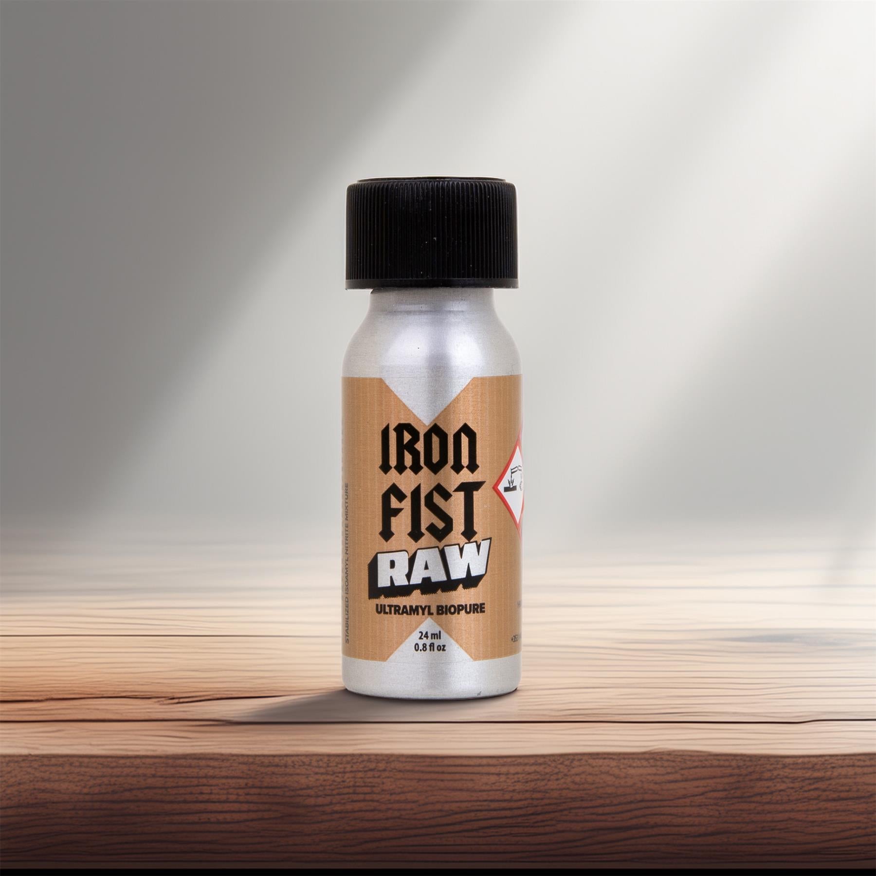 Bottle of Iron Fist Raw on a wooden surface with a gradient background
