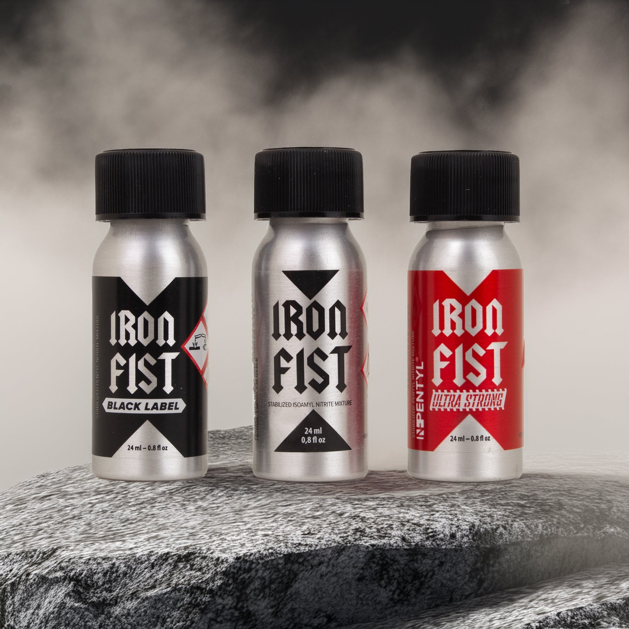 Three Iron Fist bottles on a textured surface with a dark background
